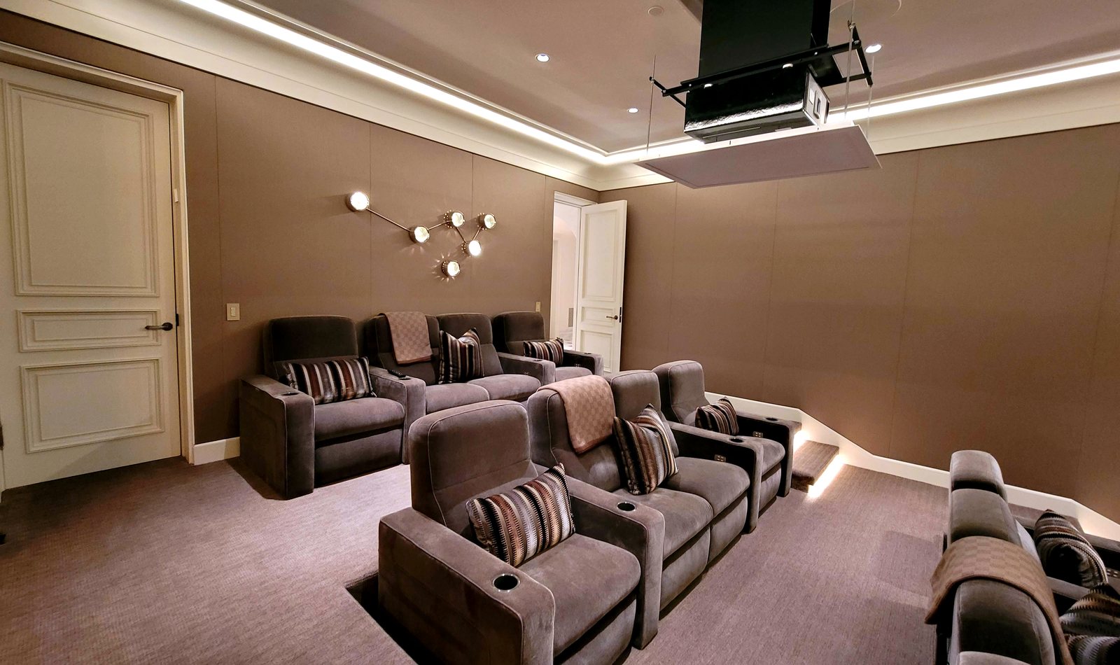 Clean projector integration in a private Houston theater room by Obsidian AV