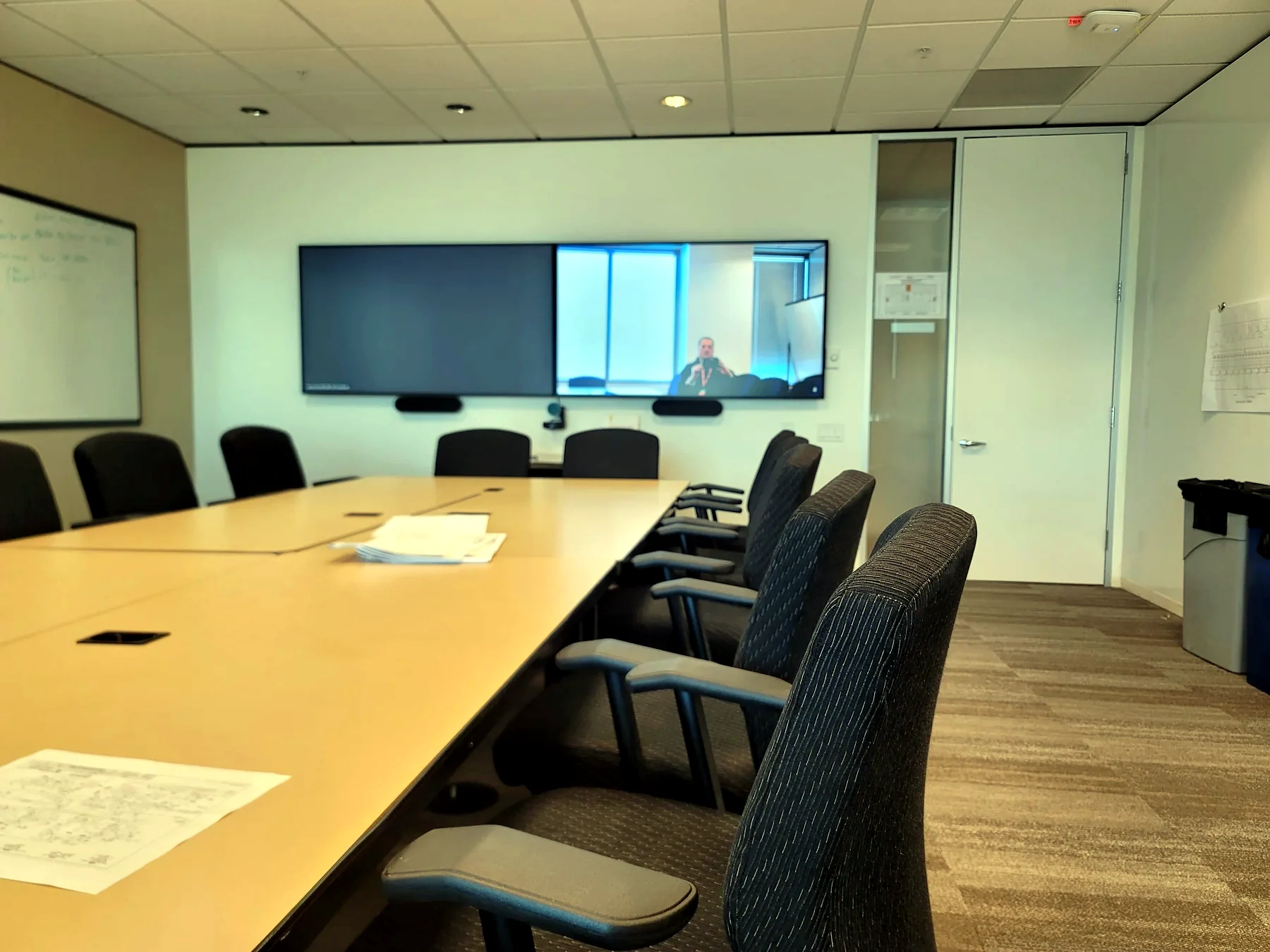 Conference room with projection screen table seating and commercial AV system