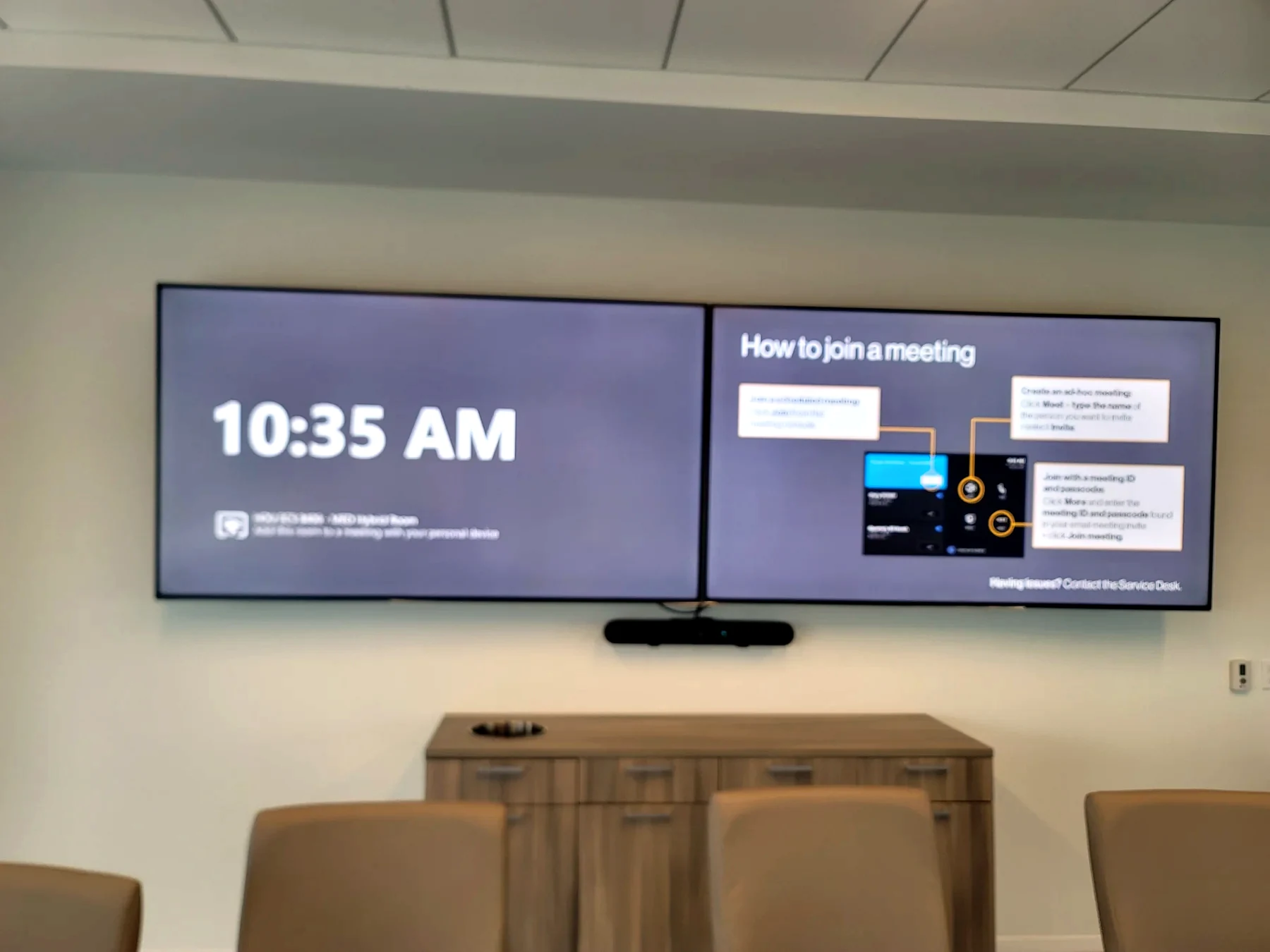 Microsoft Teams style conference room with front displays and meeting furniture